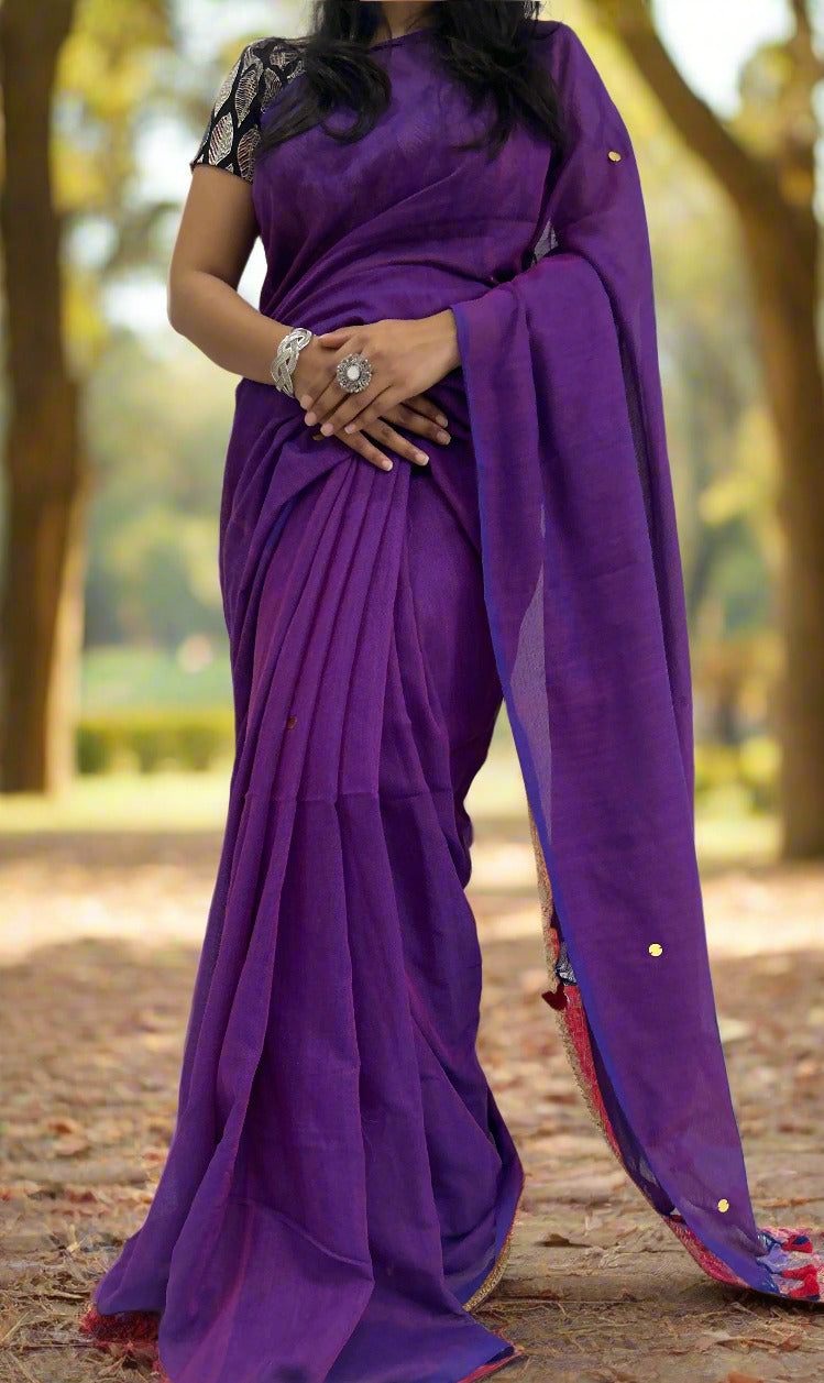 Person wearing a purple saree with a white background