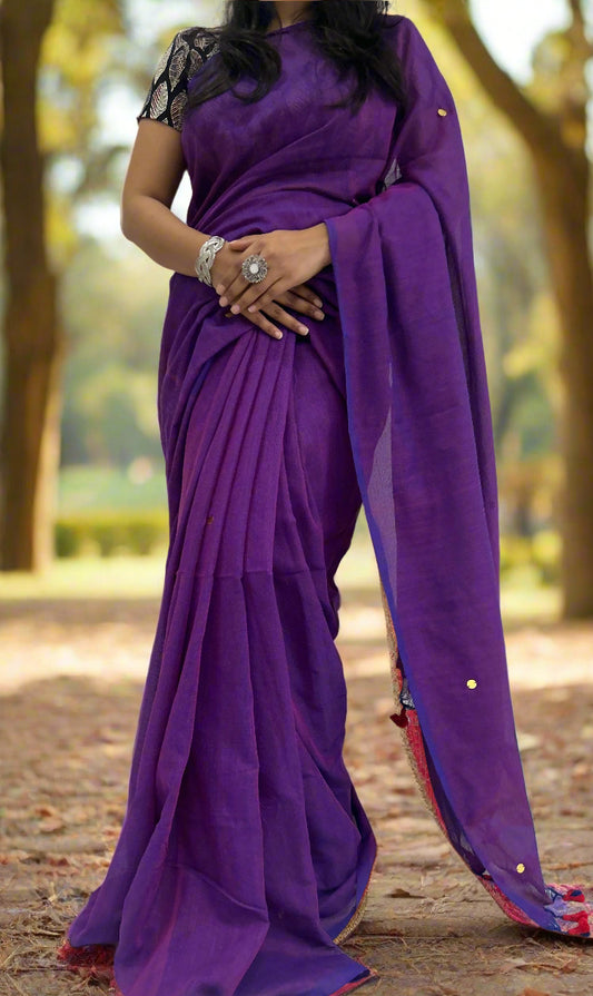 Person wearing a purple saree with a white background