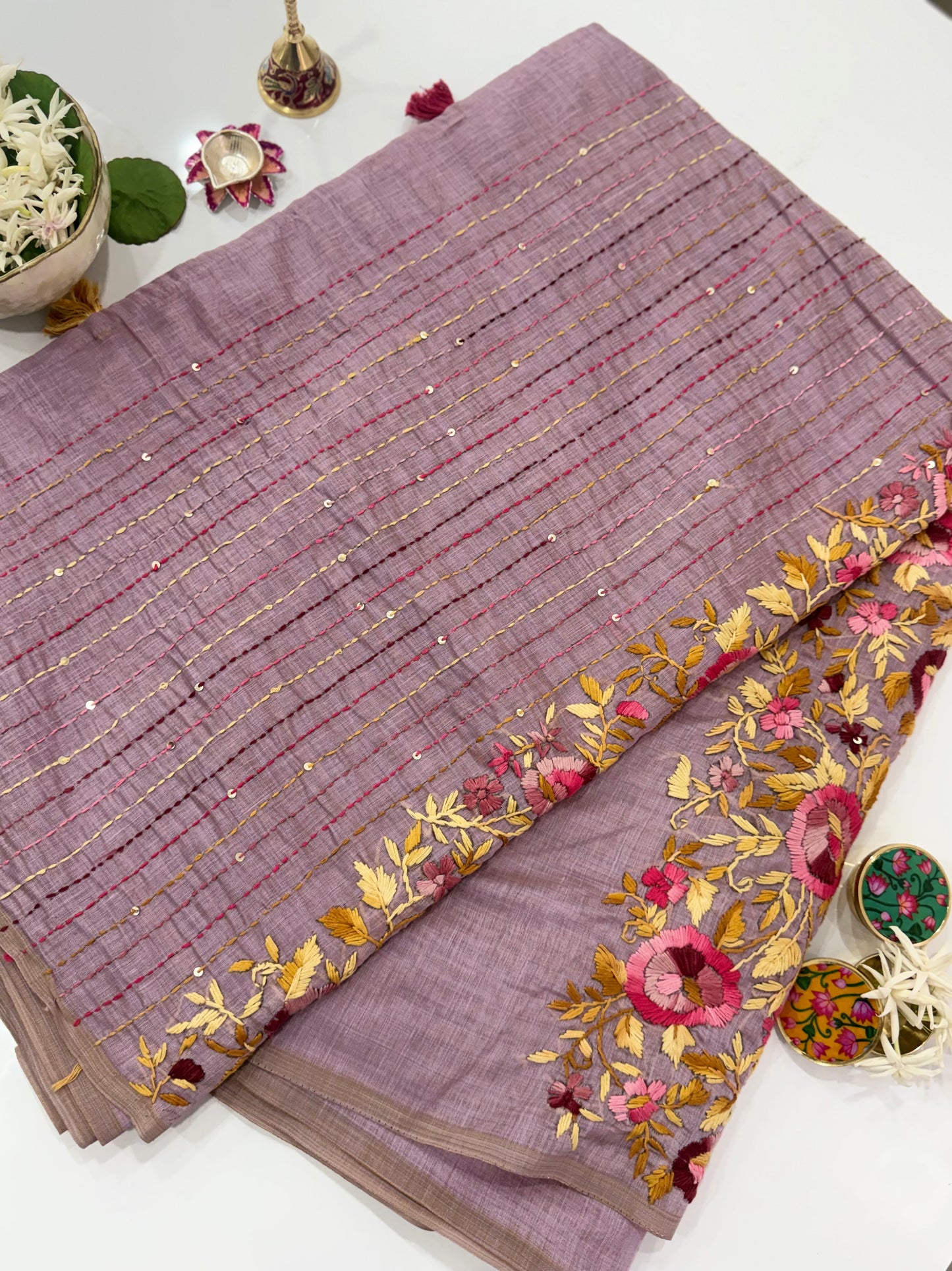 Purple saree with floral embroidery on a white background