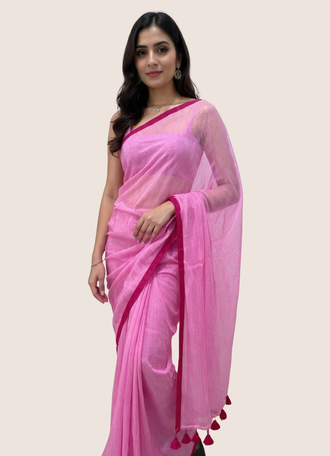 Woman wearing a pink saree with a plain background