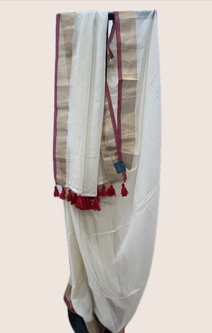 White saree with red tassels on a beige background
